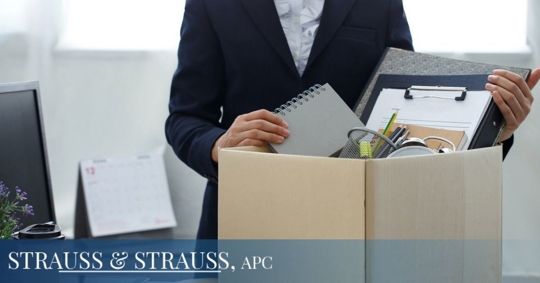 Person fired from job packing up their office supplies